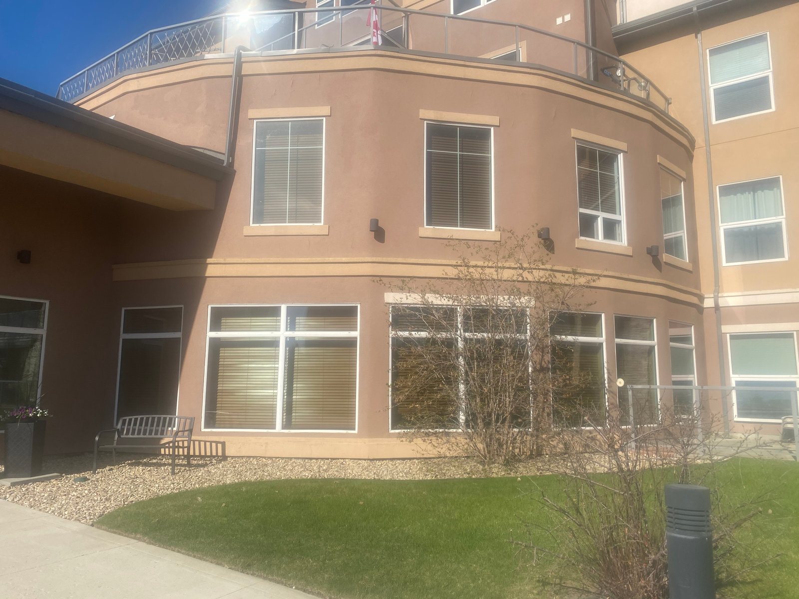 Curved EIFS façade with smooth acrylic finish on a modern building